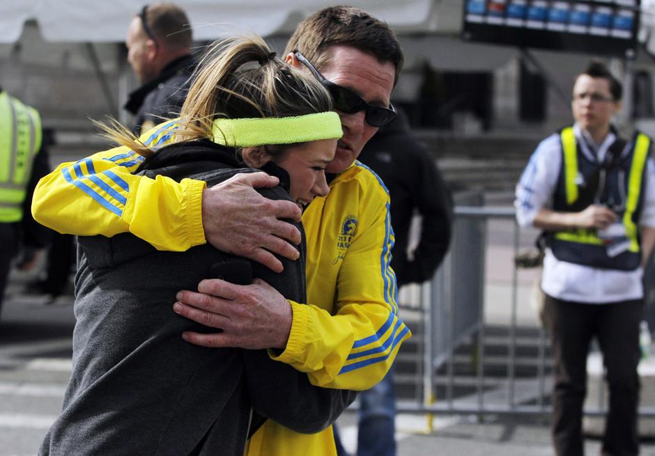 2013年4月15日，在美国波士顿，一名男子在发生爆炸后安慰一名女子。