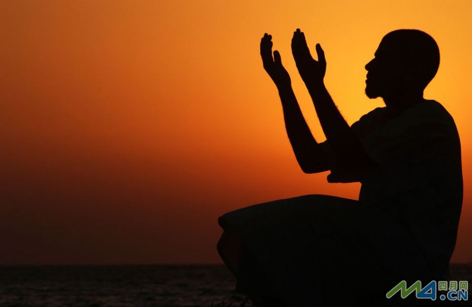 1.班加西（利比亚北部港口城市）一名斋戒了一天之后向着落日祈祷的信徒.