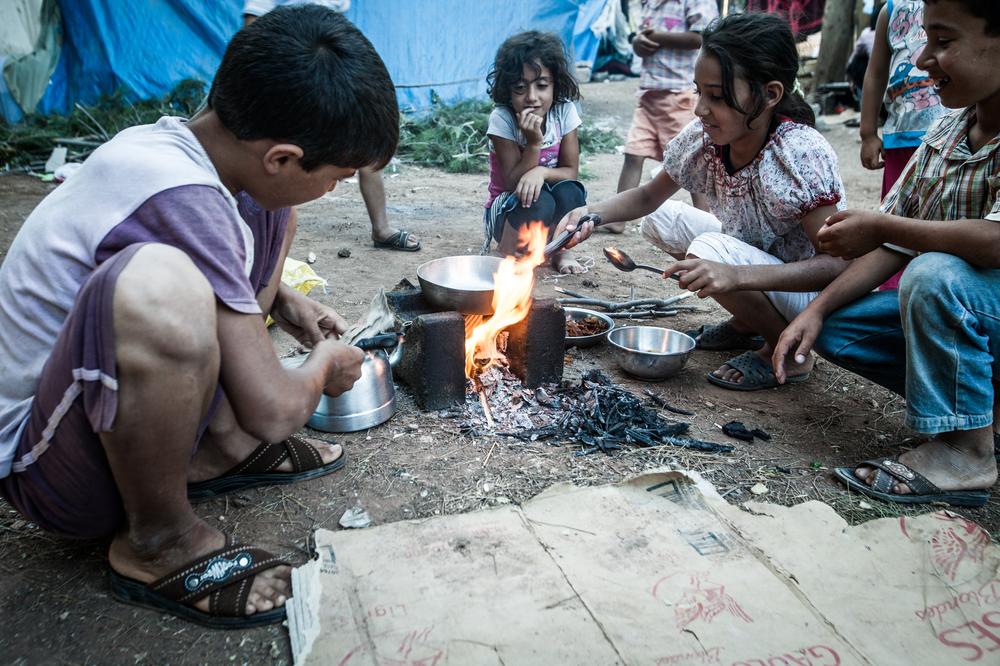 9、 叙利亚孩子们用纸箱生火做开斋饭。